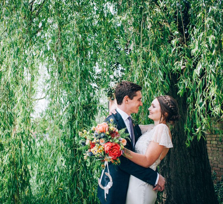 Bride in David Fielden Wedding Dress & Groom in Reiss Suit