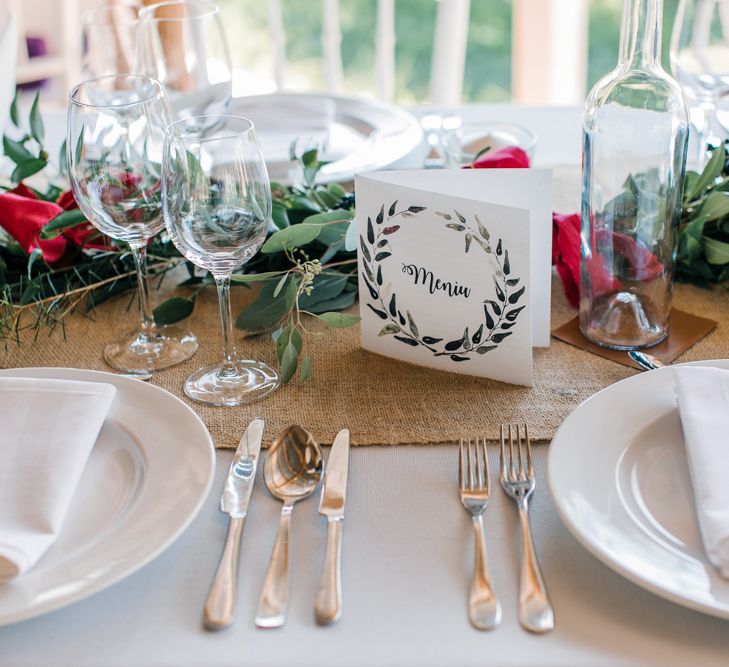 Wedding Reception Centrepieces with Greenery Table Runners & Tappered Candles in Bottles