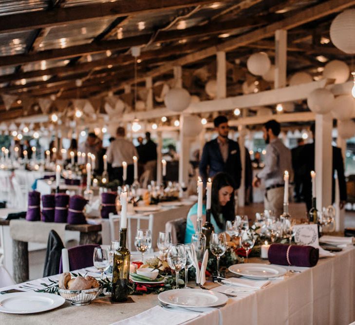 Wedding Reception Centrepieces with Greenery Table Runners & Tappered Candles in Bottles