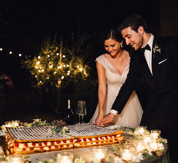 Bride & Groom Cutting The Cake