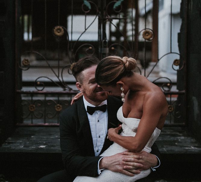 Bride sitting on lap of groom 