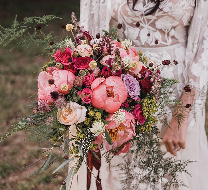 Close up of bride holding rustic pink wedding bouquet