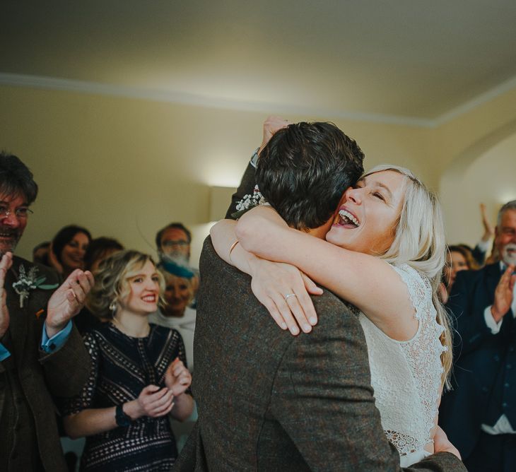 Wedding Ceremony with Bride in Anais Anette Savannah Bridal Gown & Groom in Walker Slater Tweed Suit