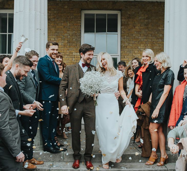 Confetti Moment with Bride in Anais Anette Savannah Bridal Gown & Groom in Walker Slater Tweed Suit