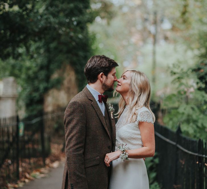 Bride in Anais Anette Savannah Bridal Gown & Groom in Walker Slater Tweed Suit