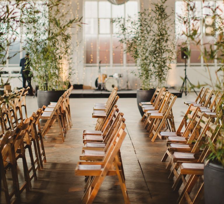 Warehouse Wedding With Wooden Chairs & Foliage Installation | Images by Frances Sales