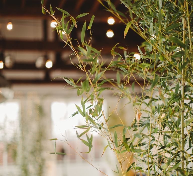 Warehouse Wedding With Wooden Chairs & Foliage Installation | Images by Frances Sales