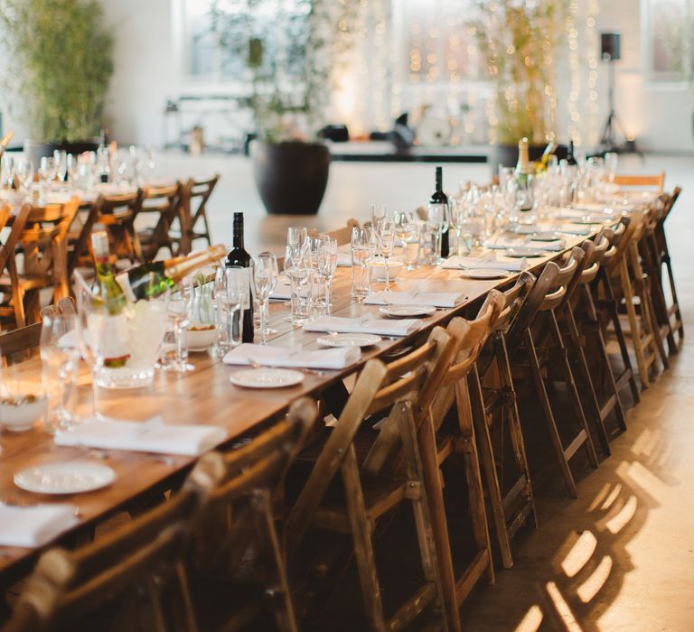 Warehouse Wedding With Wooden Chairs & Foliage Installation | Images by Frances Sales