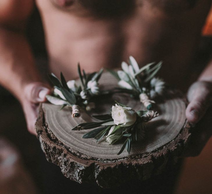 White Buttonholes on a Tree Slab