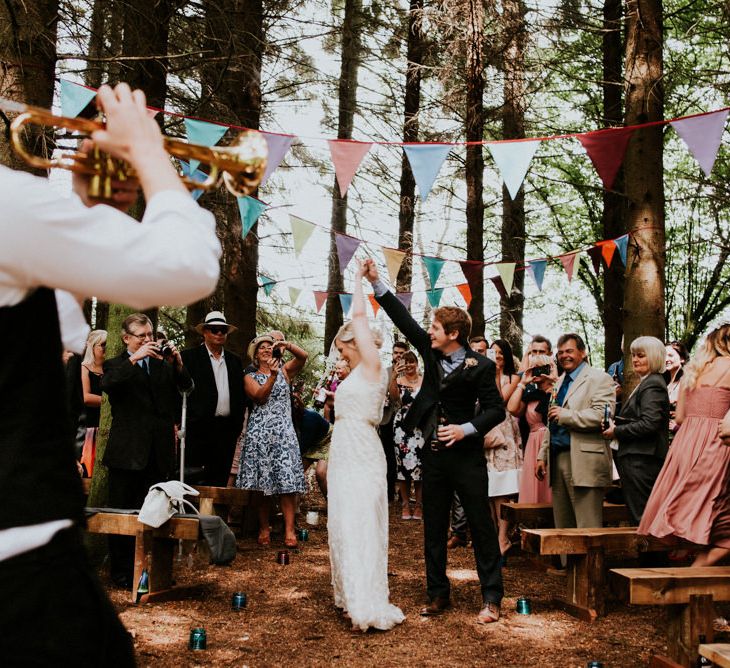 Woodland Wedding Ceremony | Bride in Catherine Deane Gown | Groom in Ben Sherman Suit, Bow Tie & Gingham Shirt | Colourful Outdoor Wedding at Lineham Farm in Leeds | Shutter Go Click Photography