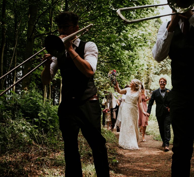 Brass Band Procession | Bride in Catherine Deane Gown | Groom in Ben Sherman Suit, Bow Tie & Gingham Shirt | Colourful Outdoor Wedding at Lineham Farm in Leeds | Shutter Go Click Photography