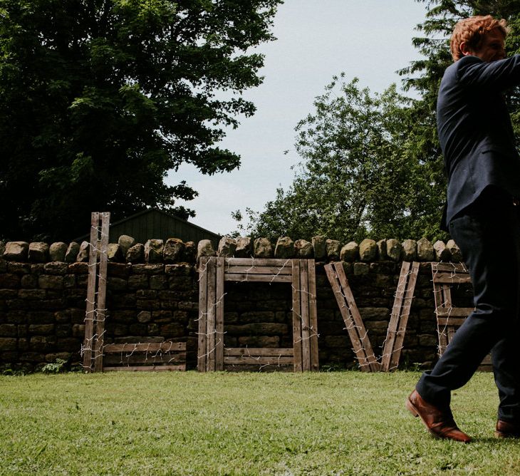 Wood LOVE Sign wrapped in Fairy Lights | Wedding Decor | Colourful Outdoor Wedding at Lineham Farm in Leeds | Shutter Go Click Photography