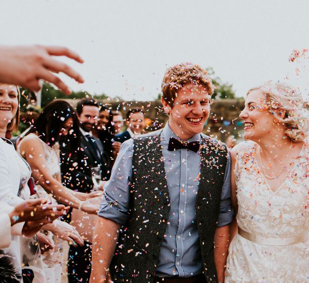 Confetti Moment | Bride in Catherine Deane Gown | Groom in Ben Sherman Suit, Bow Tie & Gingham Shirt | Colourful Barn Reception at Lineham Farm in Leeds | Shutter Go Click Photography