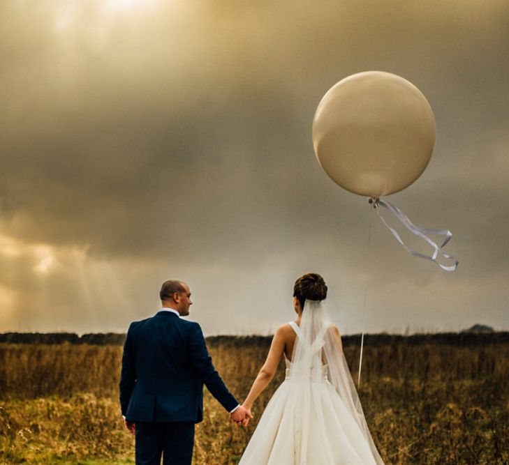 Giant Balloons | Bride in Pronovias Tami Wedding Dress | Groom in Blue Moss Bros Suit | Michelle Wood Photography