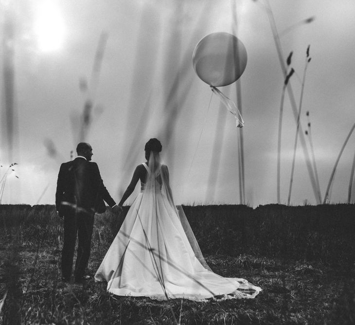 Giant Balloons | Bride in Pronovias Tami Wedding Dress | Groom in Blue Moss Bros Suit | Michelle Wood Photography