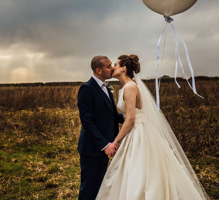 Giant Balloon | Bride in Pronovias Tami Wedding Dress | Groom in Blue Moss Bros Suit | Michelle Wood Photography