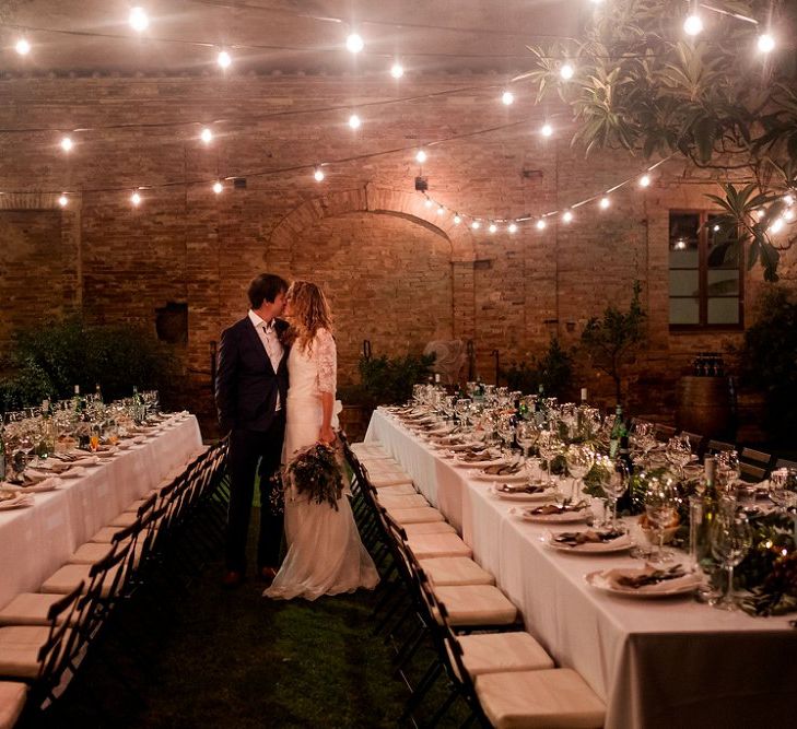 Festoon Light Reception | Bride in Low Back Atelier Endeavour Gown | Groom in Hugo Boss Suit | Destination Wedding at Pienza, Italy | Nordica Photography