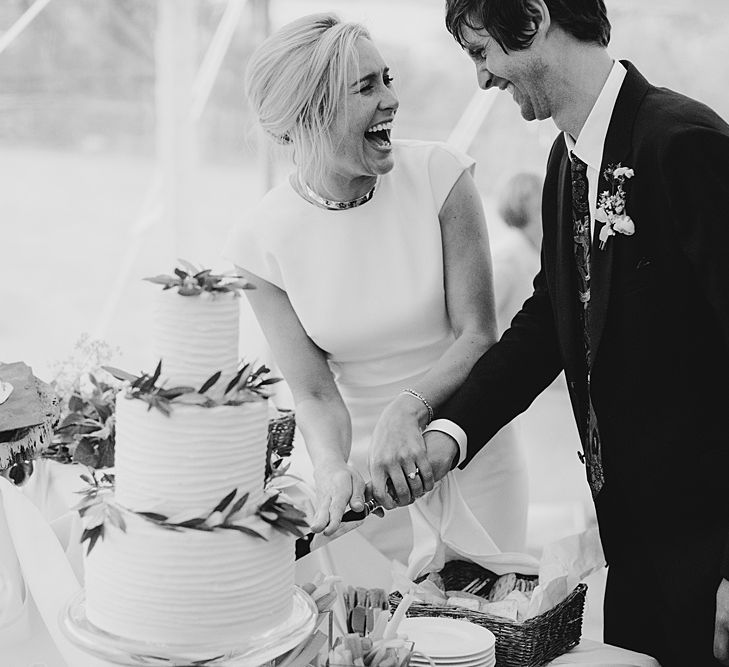 Cutting the Cake | At Home Greenery Filled Marquee Wedding in Yorkshire | Craig Williams Photography