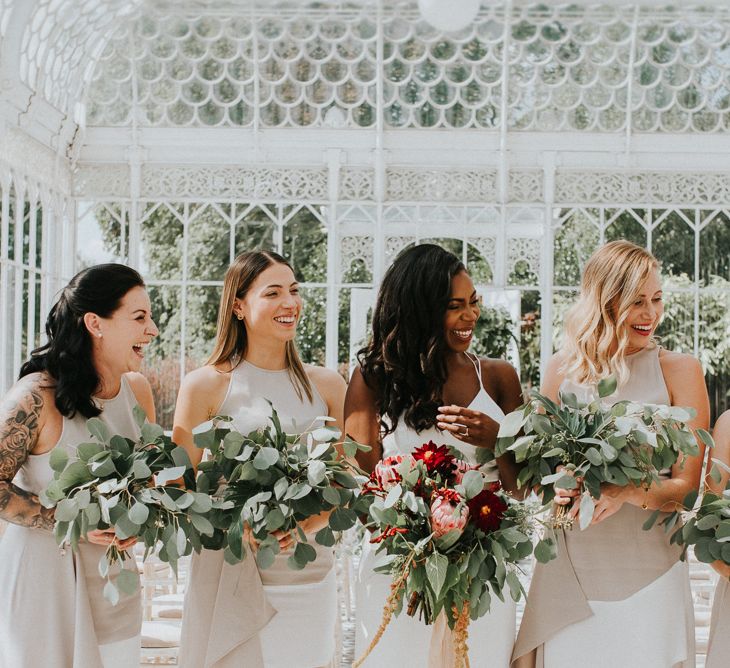 Bridal Party | Bridesmaids in White AQ/AQ Dresses | Bride in Charlie Brear Gown | Greenery & Protea Bouquets | Botanical Orangery Wedding at Horniman Museum & Gardens, London | Fern Edwards Photography