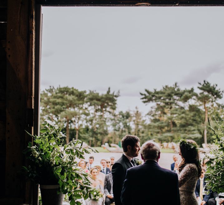 Outdoor Wedding Ceremony | Bride in Needle & Thread Bridal Gown | Groom in Ted Baker Suit | Rustic, Greenery Wedding at Pimhill Barns Shropshire | Clara Cooper Photography | Second Shooter Helen Jane Smiddy Photography