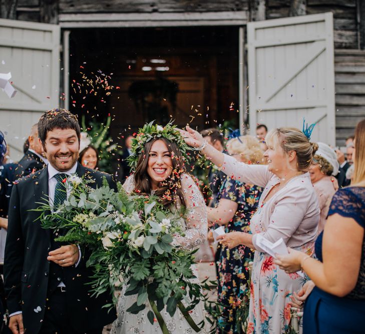 Confetti Moment | Bride in Needle & Thread Bridal Gown | Groom in Ted Baker Suit | Rustic, Greenery Wedding at Pimhill Barns Shropshire | Clara Cooper Photography | Second Shooter Helen Jane Smiddy Photography