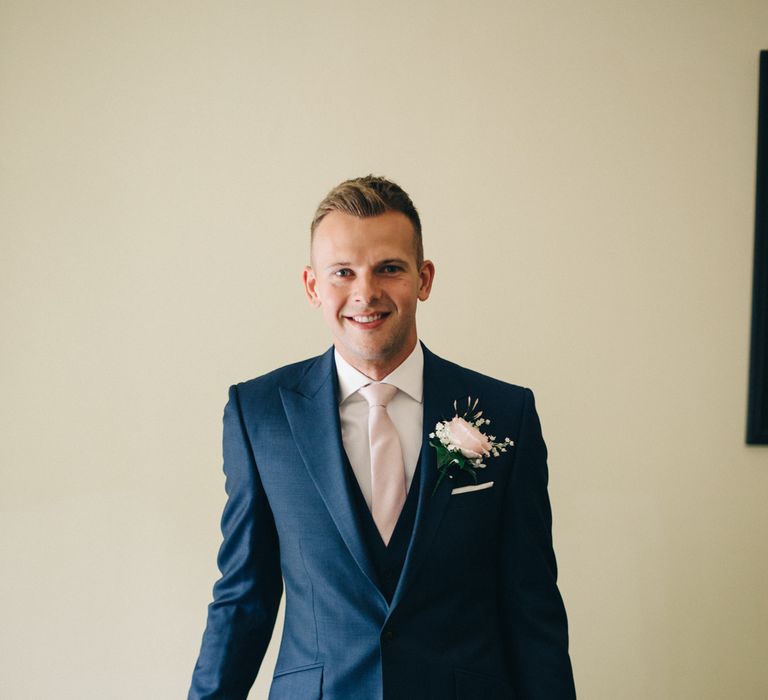 Groom in Navy Reiss Suit | Image by <a href="https://www.mandjphotos.com/" target="_blank">M&J Photography</a>