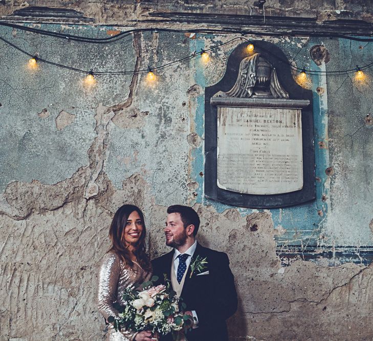 Bride In Gold Sequinned Dress For A Relaxed Wedding At Asylum Chapel With Bridesmaids In Mismatched High Street Dresses And Images by Lovestruck Photography