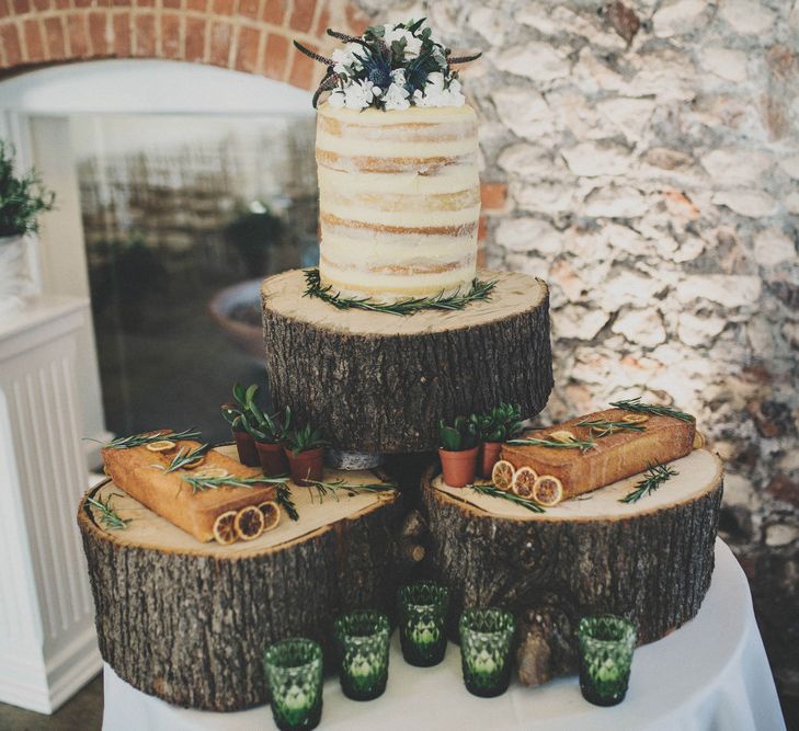 Rustic Cake Table with semi Naked Wedding Cake on Tree Stump Cake Stand