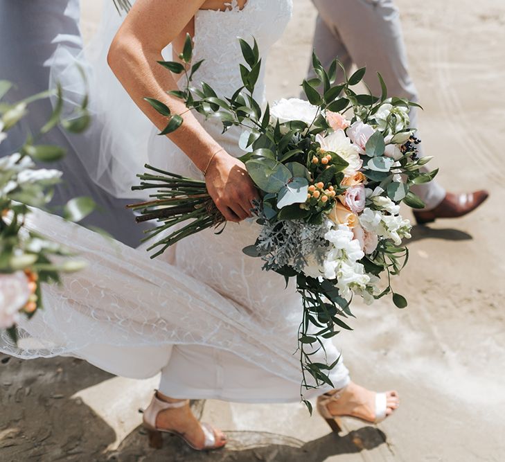 Bride in Sally Eagle 'Estelle' Gown | Andrea Biani Shoes | Outdoor Coastal Wedding at Ohawini Bay in New Zealand with Natural Garden Party Reception | Miss Gen Photography