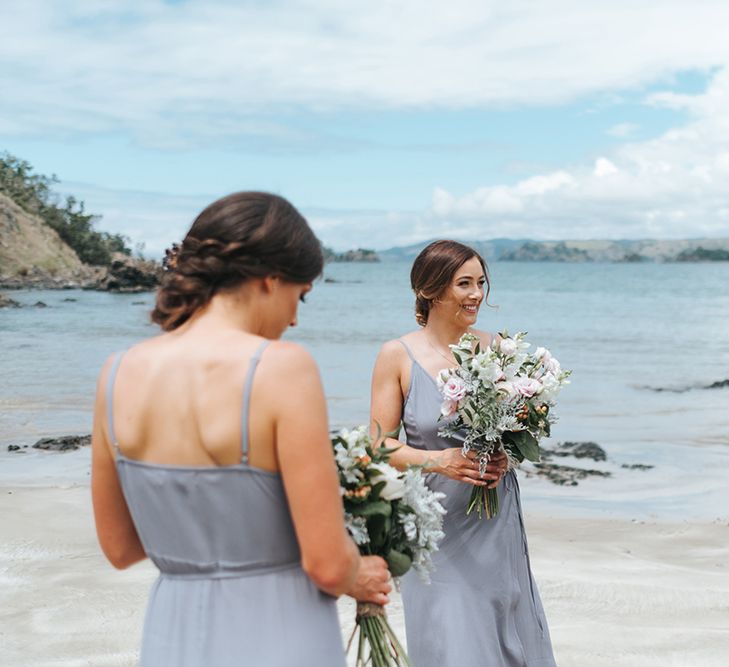 Bridesmaids in Powder Blue Evolution Clothing Dresses | Outdoor Coastal Wedding at Ohawini Bay in New Zealand with Natural Garden Party Reception | Miss Gen Photography