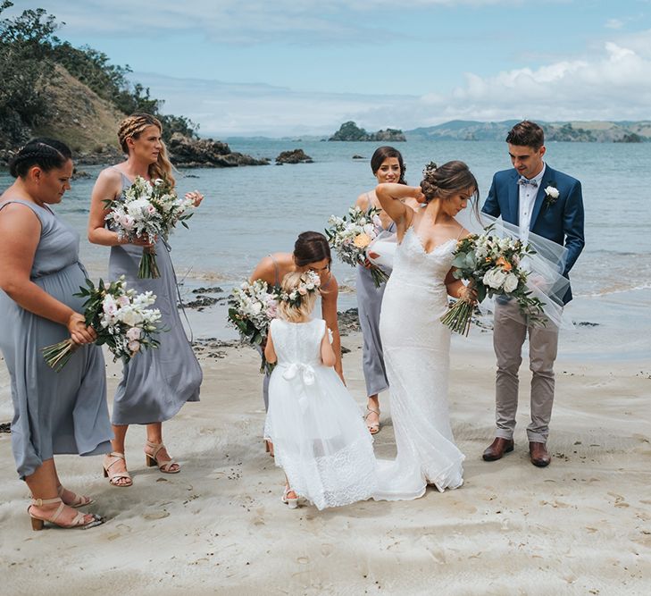 Wedding Party | Bride in Estelle Sally Eagle Gown | Bridesmaids in Powder Blue Evolution Clothing Dresses | Groomsmen in Chinos & Blazers | Outdoor Coastal Wedding at Ohawini Bay in New Zealand with Natural Garden Party Reception | Miss Gen Photography