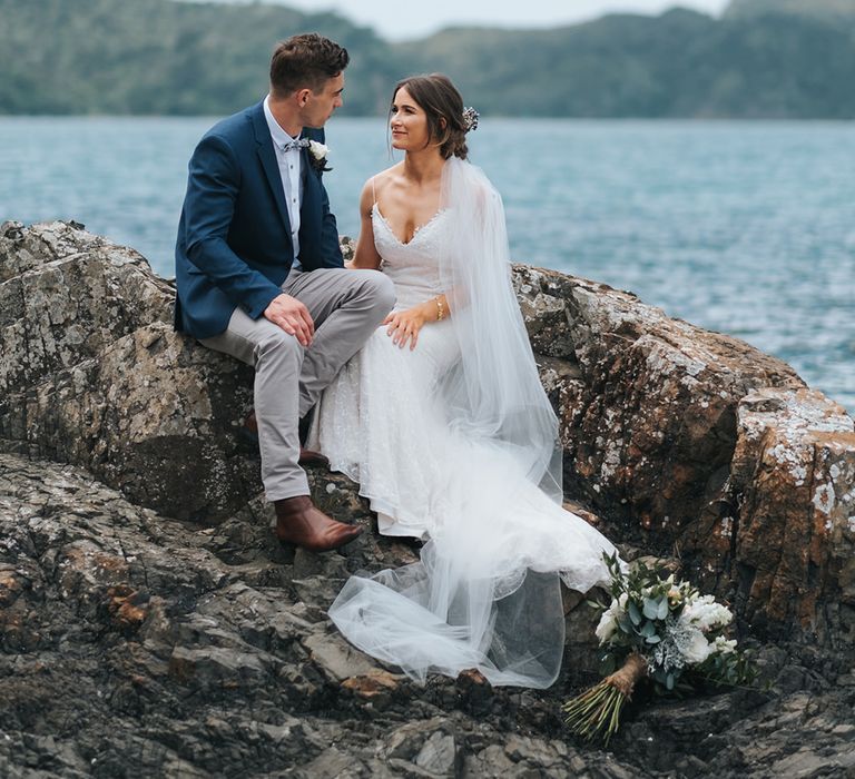 Bride in Estelle Sally Eagle Gown | Groom in Chinos & Blazer | Outdoor Coastal Wedding at Ohawini Bay in New Zealand with Natural Garden Party Reception | Miss Gen Photography