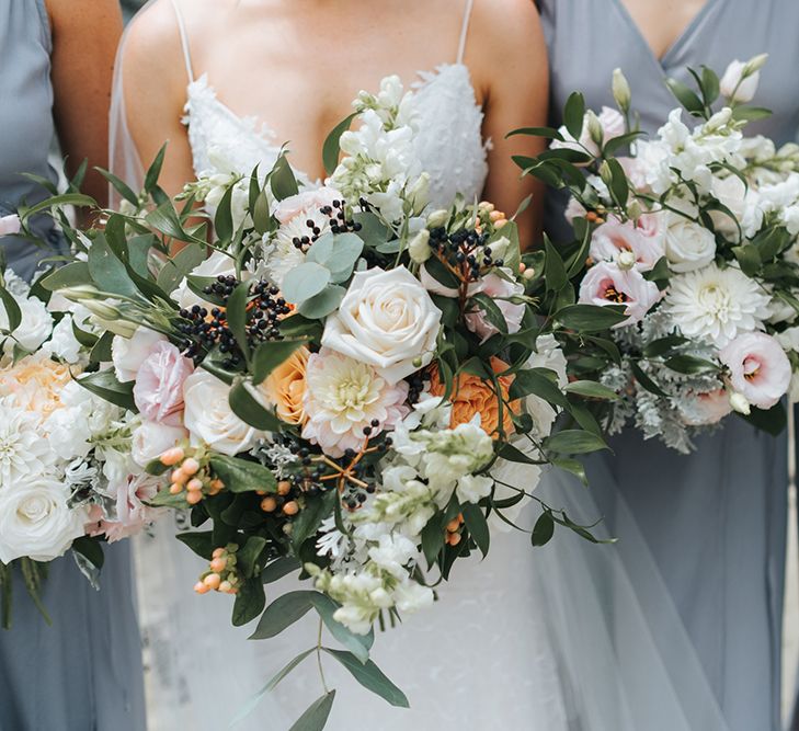 Romantic Bouquets | Bride in Estelle Sally Eagle Gown | Bridesmaids in Powder Blue Evolution Clothing Dresses | Outdoor Coastal Wedding at Ohawini Bay in New Zealand with Natural Garden Party Reception | Miss Gen Photography