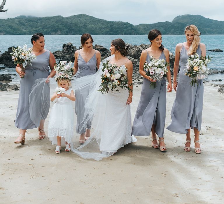 Bridal Party | Bride in Estelle Sally Eagle Gown | Bridesmaids in Powder Blue Evolution Clothing Dresses | Outdoor Coastal Wedding at Ohawini Bay in New Zealand with Natural Garden Party Reception | Miss Gen Photography