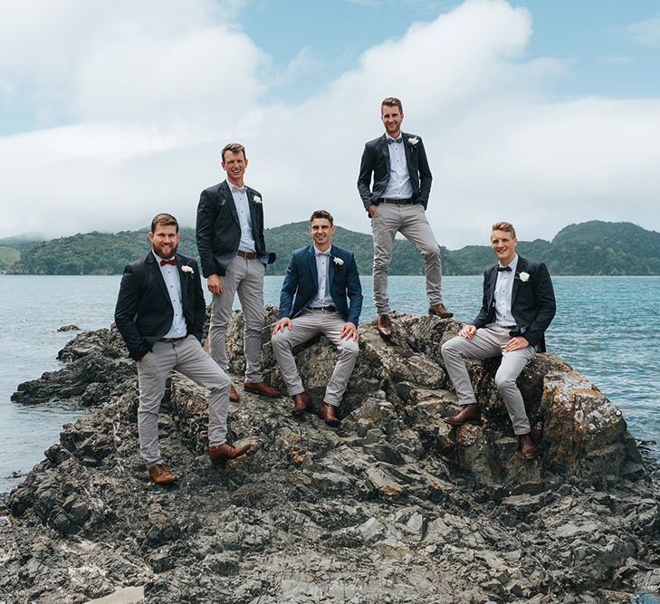 Groomsmen in Grey Chinos & Navy Blazers | Outdoor Coastal Wedding at Ohawini Bay in New Zealand with Natural Garden Party Reception | Miss Gen Photography