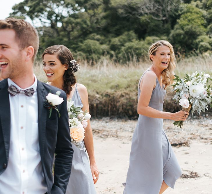 Wedding Party | Bride in Estelle Sally Eagle Gown | Bridesmaids in Powder Blue Evolution Clothing Dresses | Groomsmen in Grey Chinos & Navy Blazers | Outdoor Coastal Wedding at Ohawini Bay in New Zealand with Natural Garden Party Reception | Miss Gen Photography