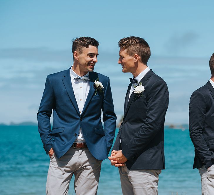 Wedding Ceremony | Groomsmen in Grey Chinos & Navy Blazers | Outdoor Coastal Wedding at Ohawini Bay in New Zealand with Natural Garden Party Reception | Miss Gen Photography