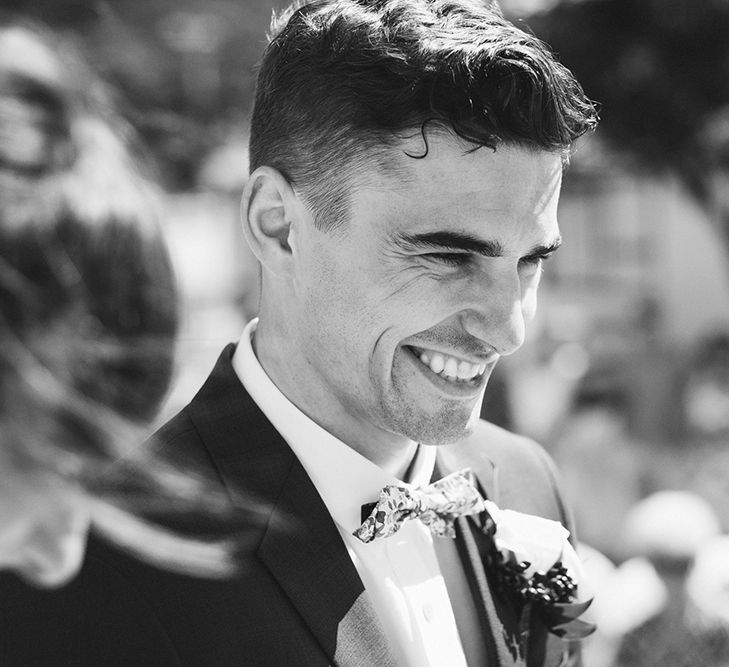 Wedding Ceremony | Groom in Grey Chinos & Navy Blazer | Outdoor Coastal Wedding at Ohawini Bay in New Zealand with Natural Garden Party Reception | Miss Gen Photography