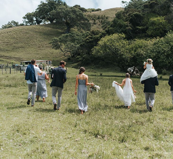 Wedding Party | Bride in Estelle Sally Eagle Gown | Bridesmaids in Powder Blue Evolution Clothing Dresses | Groomsmen in Grey Chinos & Navy Blazers | Outdoor Coastal Wedding at Ohawini Bay in New Zealand with Natural Garden Party Reception | Miss Gen Photography