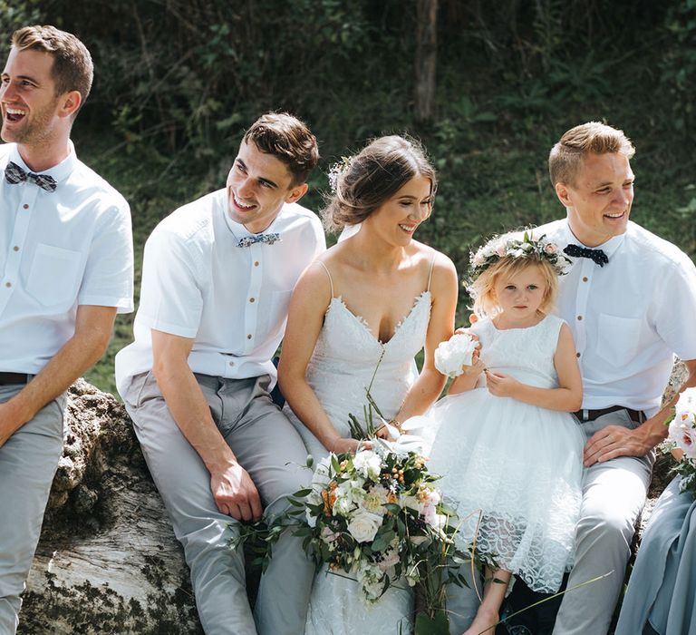 Wedding Party | Bride in Estelle Sally Eagle Gown | Flower Girl | Groomsmen in Grey Chinos & Navy Blazers | Outdoor Coastal Wedding at Ohawini Bay in New Zealand with Natural Garden Party Reception | Miss Gen Photography