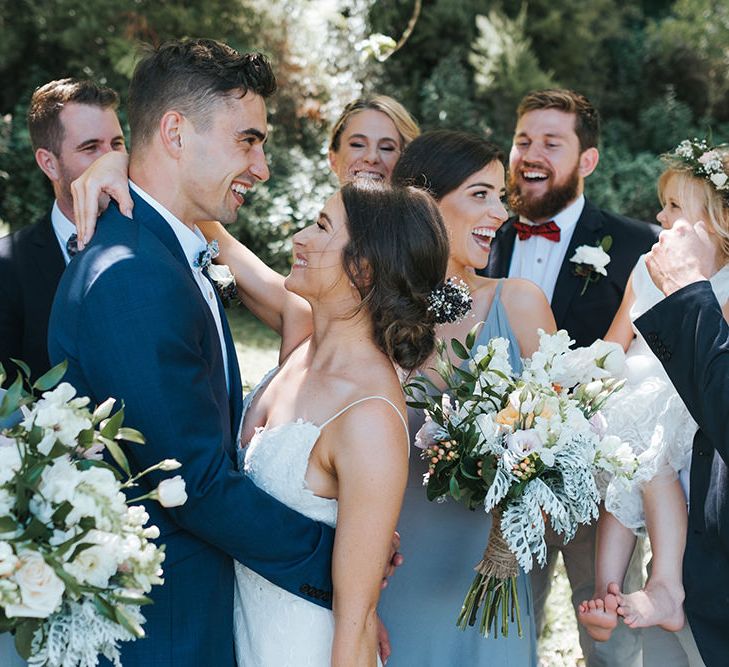 Wedding Party | Bride in Estelle Sally Eagle Gown | Bridesmaids in Powder Blue Evolution Clothing Dresses | Groomsmen in Grey Chinos & Navy Blazers | Outdoor Coastal Wedding at Ohawini Bay in New Zealand with Natural Garden Party Reception | Miss Gen Photography