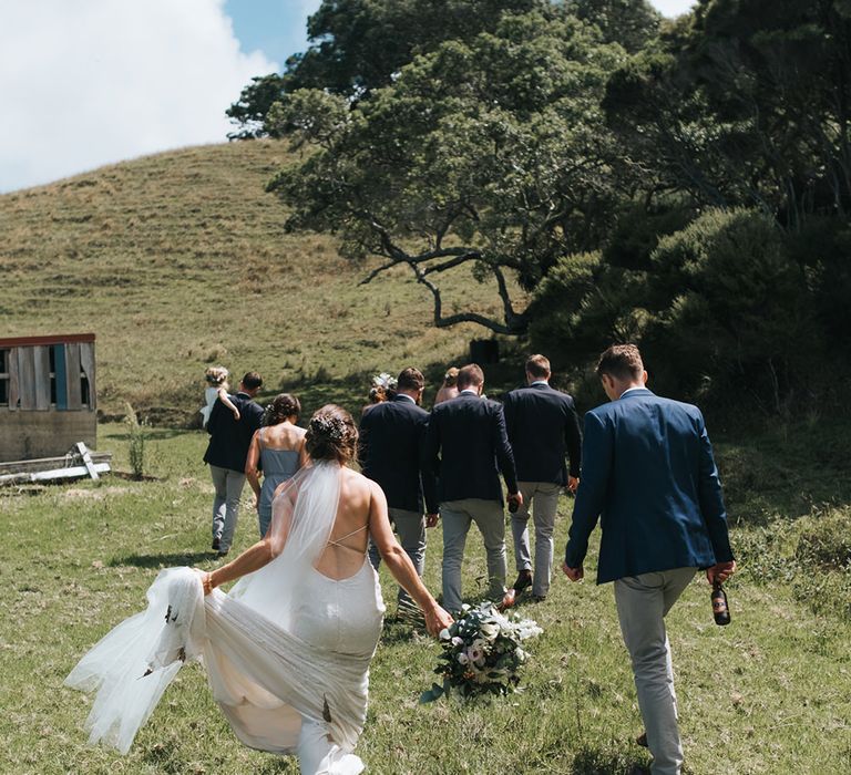 Wedding Party | Bride in Estelle Sally Eagle Gown | Bridesmaids in Powder Blue Evolution Clothing Dresses | Groomsmen in Grey Chinos & Navy Blazers | Outdoor Coastal Wedding at Ohawini Bay in New Zealand with Natural Garden Party Reception | Miss Gen Photography