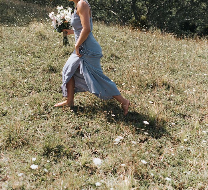 Bridesmaid in Powder Blue Evolution Clothing Dress | Outdoor Coastal Wedding at Ohawini Bay in New Zealand with Natural Garden Party Reception | Miss Gen Photography