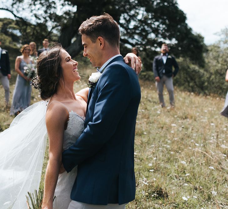 Wedding Party | Bride in Estelle Sally Eagle Gown | Bridesmaids in Powder Blue Evolution Clothing Dresses | Groomsmen in Grey Chinos & Navy Blazers | Outdoor Coastal Wedding at Ohawini Bay in New Zealand with Natural Garden Party Reception | Miss Gen Photography