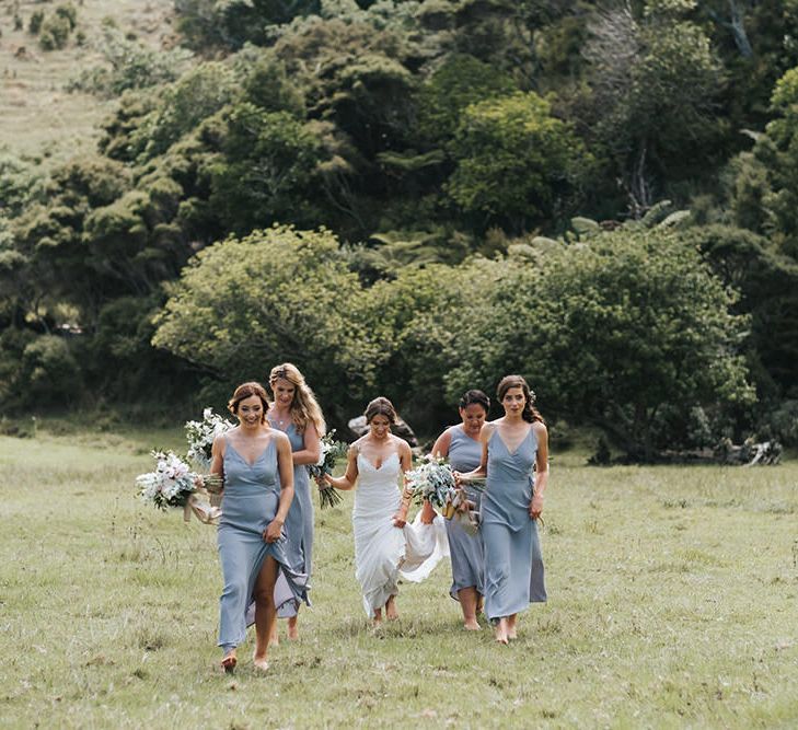 Wedding Party | Bride in Estelle Sally Eagle Gown | Bridesmaids in Powder Blue Evolution Clothing Dresses | Groomsmen in Grey Chinos & Navy Blazers | Outdoor Coastal Wedding at Ohawini Bay in New Zealand with Natural Garden Party Reception | Miss Gen Photography