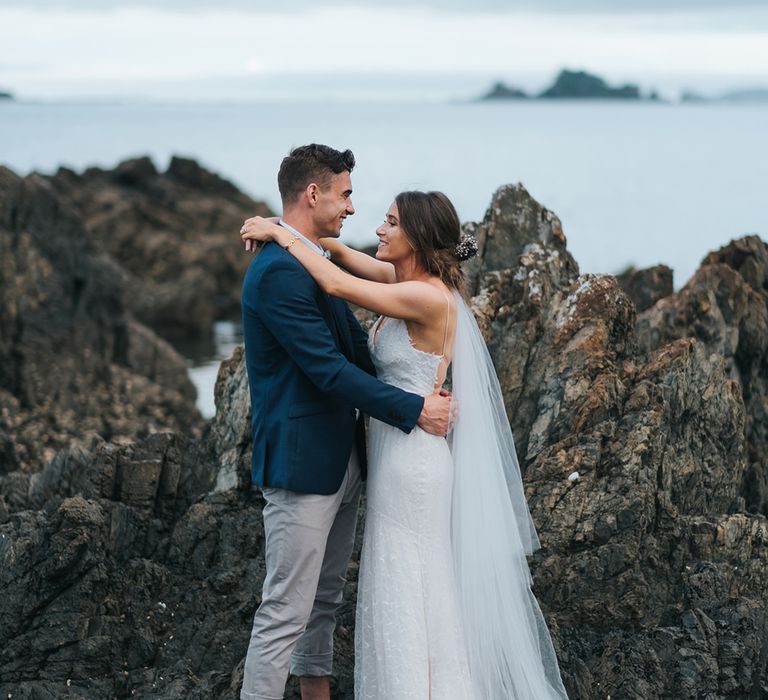 Bride in Estelle Sally Eagle Gown | Groom in Chinos & Blazer | Outdoor Coastal Wedding at Ohawini Bay in New Zealand with Natural Garden Party Reception | Miss Gen Photography