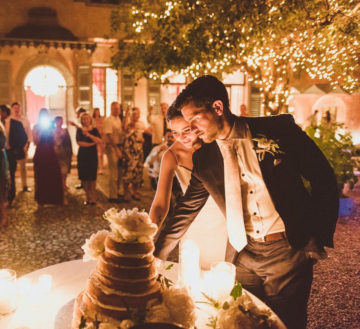 Cutting the Cake | Bride in Karen Willis Holmes Gown | Groom in Navy Peter Jackson Suit | Outdoor Destination Wedding at Villa Regina Teodolinda, Lake Como, Italy | Matt Penberthy Photography