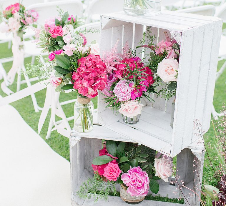 Outdoor Wedding Ceremony With White Chairs & Pink Floral Chairbacks