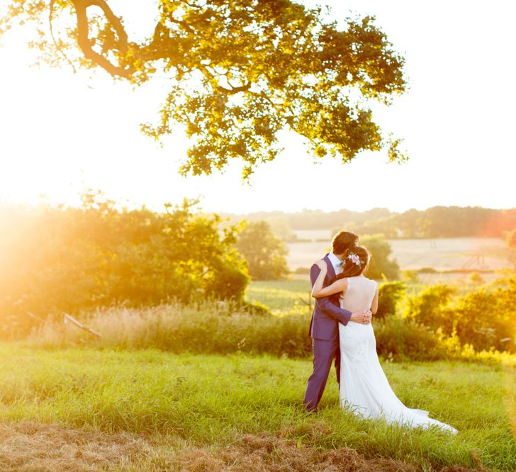 Bride in Pronovias Gown & Groom Navy in Kin by John Lewis Suit