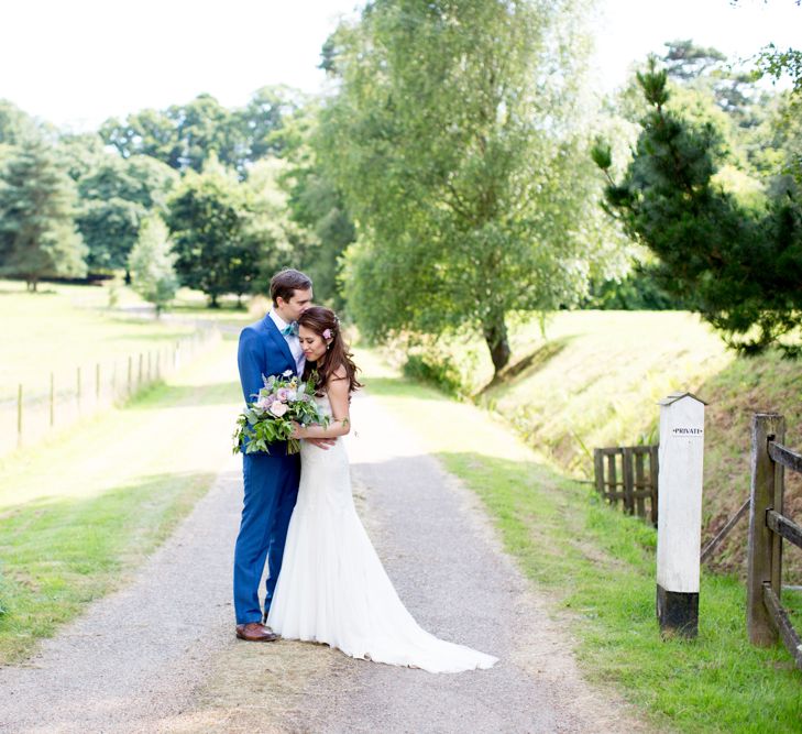 Bride in Pronovias Gown & Groom Navy in Kin by John Lewis Suit